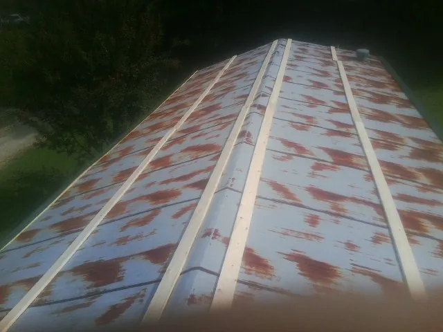 Rusted metal roof panels with new wood purlins before replacement — Storm Damage Roof Repair in Mount Crawford by Roofing Brothers