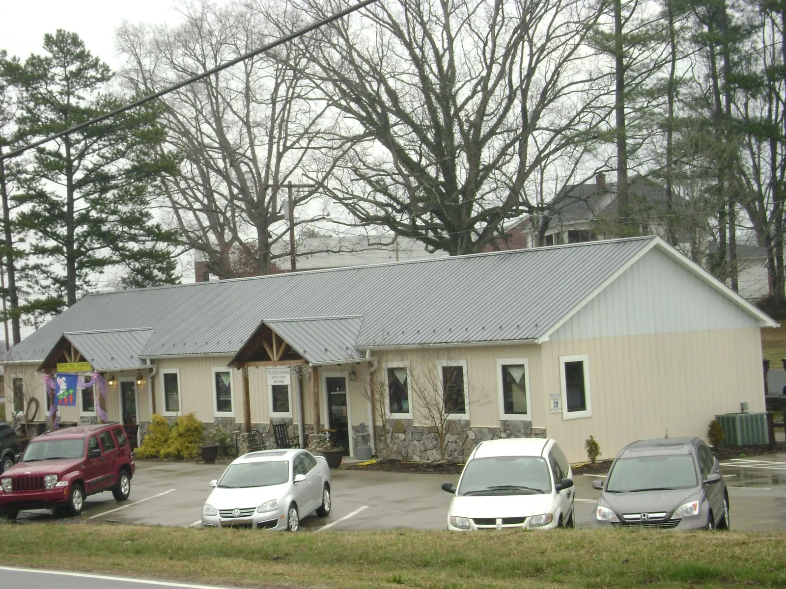 Gray metal roof with timber entry brackets on a small commercial building in Mount Crawford
