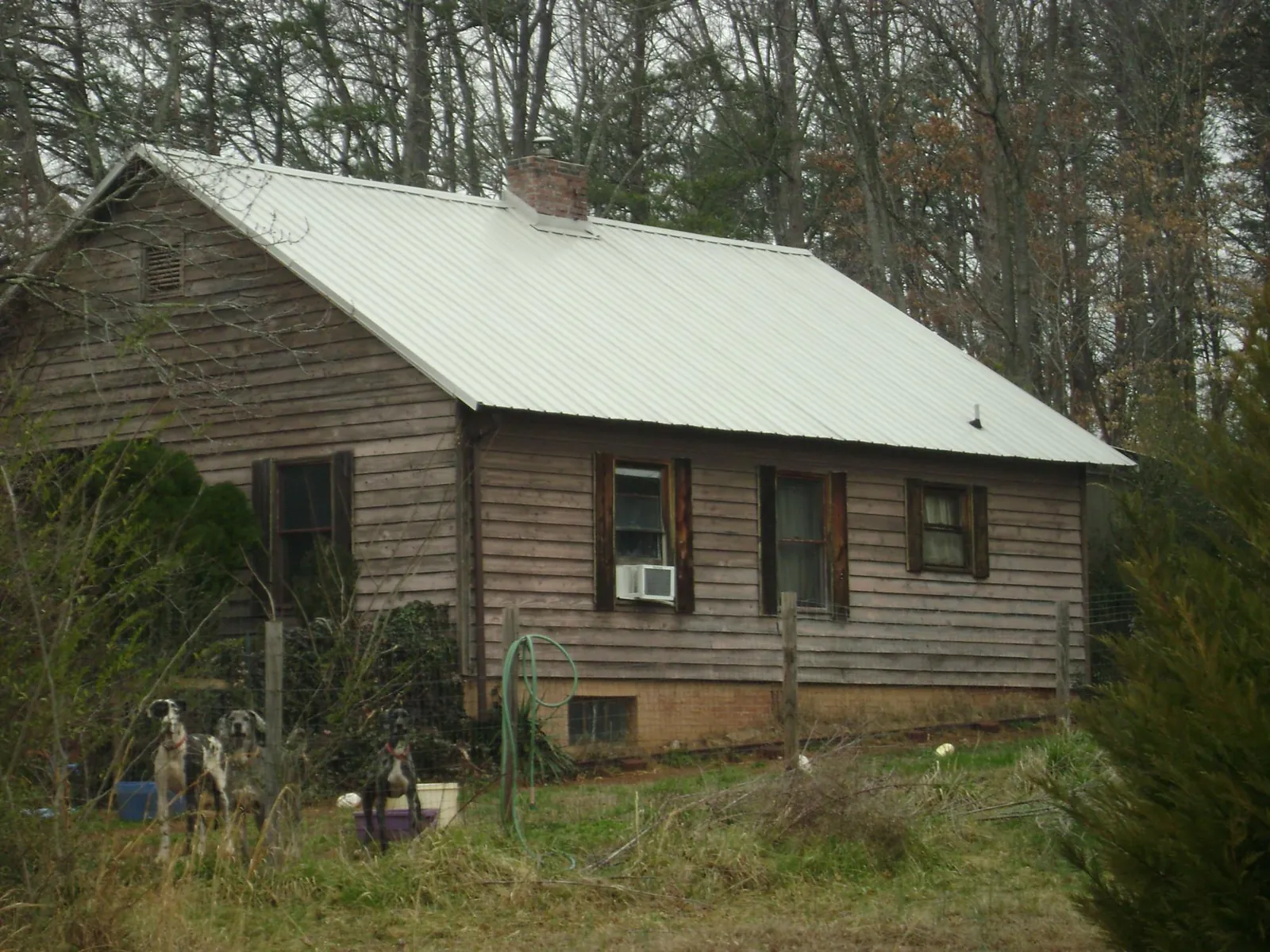 White metal roof on an old wood sided farmhouse, from a Metal Roof Installation job in Mount Crawford